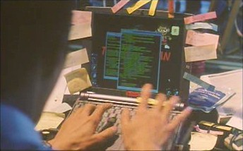 Shinji Mimura types green-on-black text with a laptop.